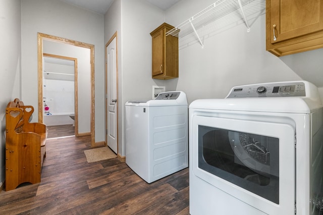 laundry area with washing machine and dryer, cabinet space, dark wood-type flooring, and baseboards