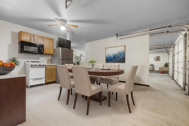 dining space with light colored carpet and ceiling fan
