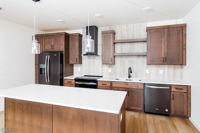 kitchen featuring wall chimney range hood, appliances with stainless steel finishes, backsplash, and sink