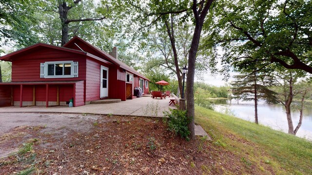 exterior space featuring a patio and a water view