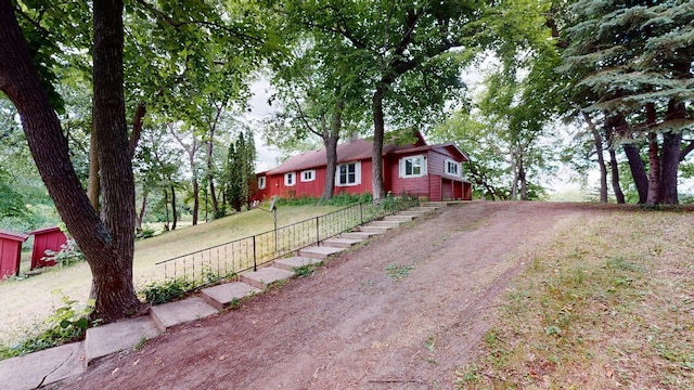 single story home with an outdoor structure