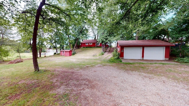 view of yard with a storage shed and a garage