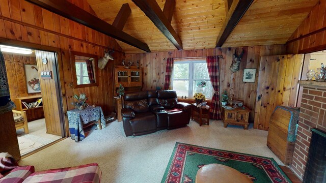 carpeted living room featuring lofted ceiling with beams, wood ceiling, wooden walls, and a brick fireplace