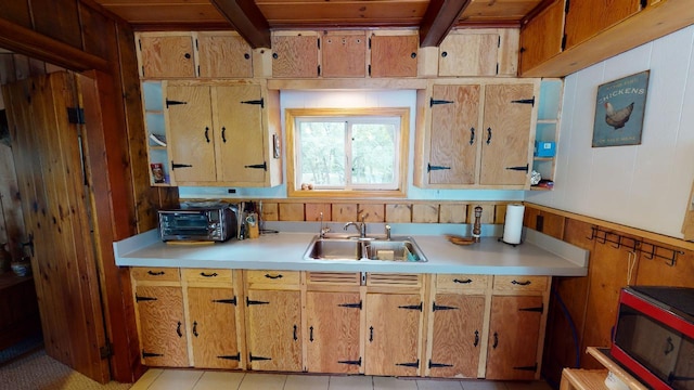 kitchen featuring light tile patterned floors and sink