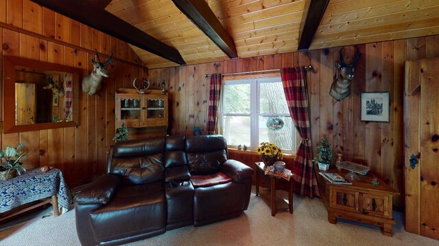 living room featuring carpet, lofted ceiling with beams, and wooden walls