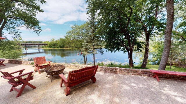 view of patio featuring a water view and an outdoor fire pit