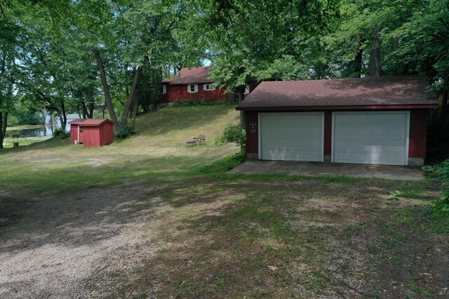 view of yard with a garage and a shed