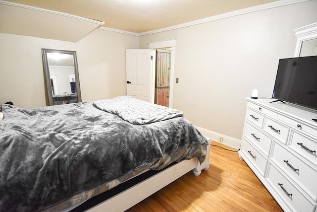 bedroom with light hardwood / wood-style floors and ornamental molding