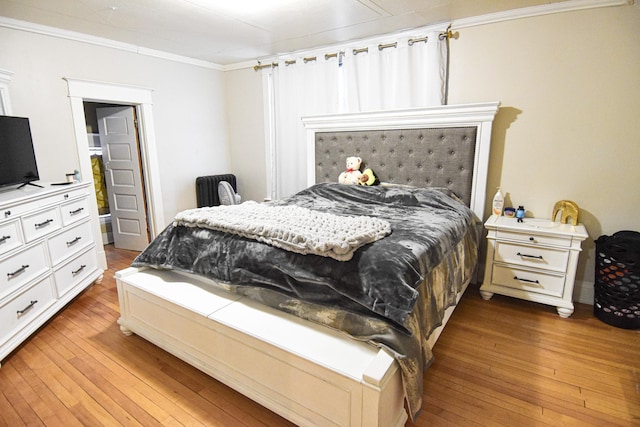 bedroom featuring hardwood / wood-style floors and ornamental molding