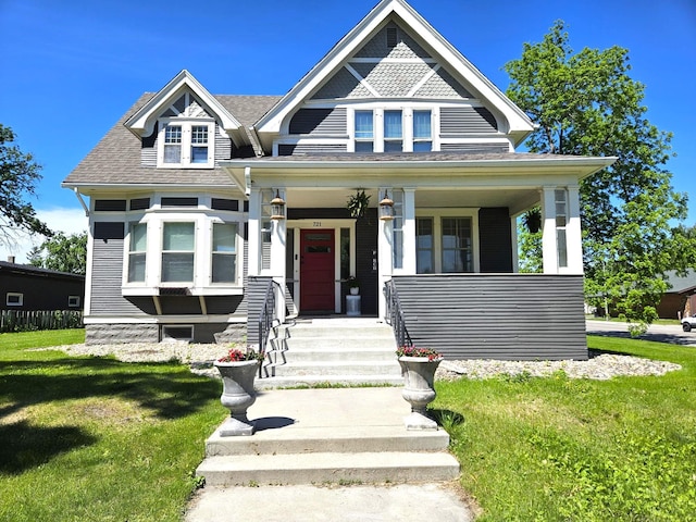 721 Labree Ave N, Thief River Falls, MN 56701 - victorian house featuring a front yard, covered porch, and roof with shingles