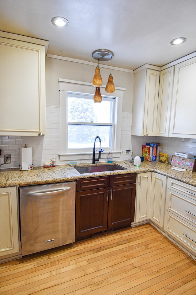 721 Labree Ave N, Thief River Falls, MN 56701 - kitchen featuring stainless steel dishwasher, a sink, backsplash, light wood-style floors, and recessed lighting