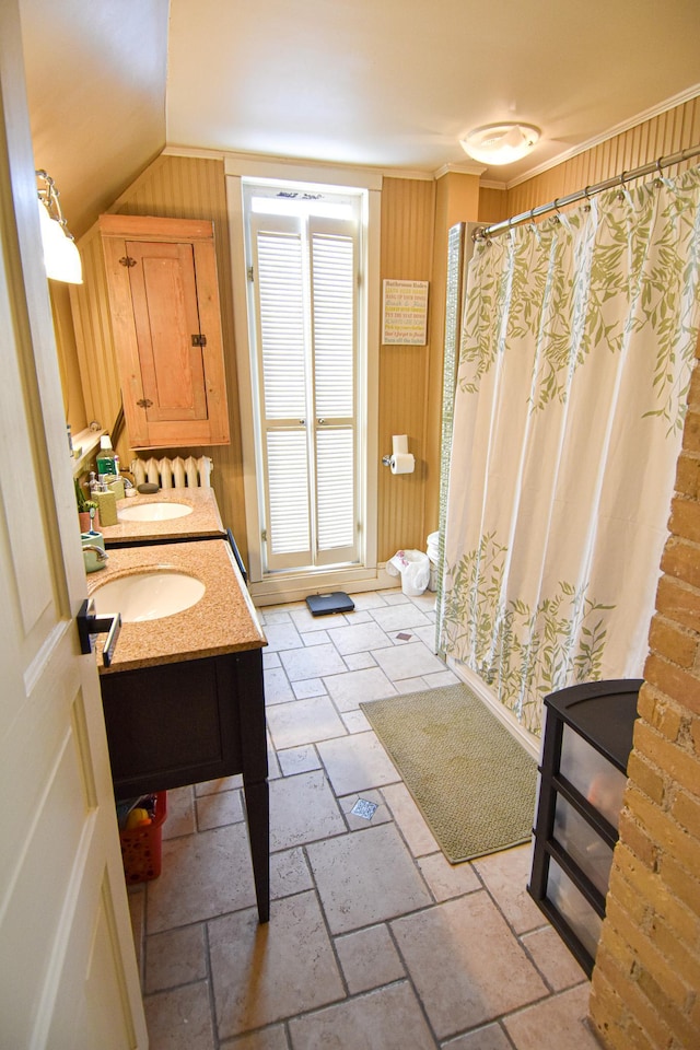 721 Labree Ave N, Thief River Falls, MN 56701 - bathroom with vaulted ceiling, stone tile floors, double vanity, a shower with curtain, and wood walls