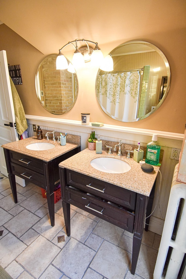 721 Labree Ave N, Thief River Falls, MN 56701 - full bathroom with stone tile flooring, two vanities, and a wainscoted wall