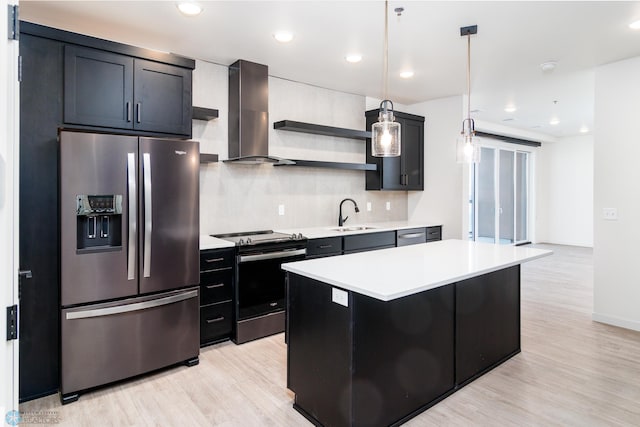 kitchen with wall chimney exhaust hood, decorative light fixtures, decorative backsplash, a kitchen island, and appliances with stainless steel finishes