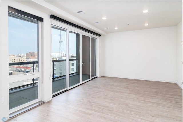 unfurnished room with light wood-type flooring