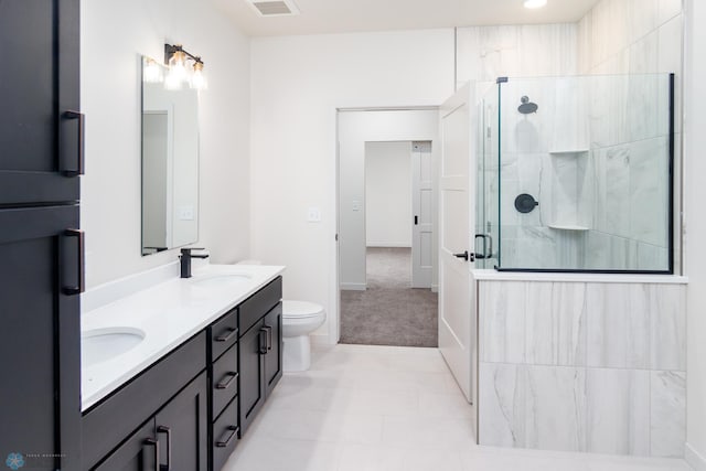 bathroom with tile patterned flooring, vanity, toilet, and a shower with door