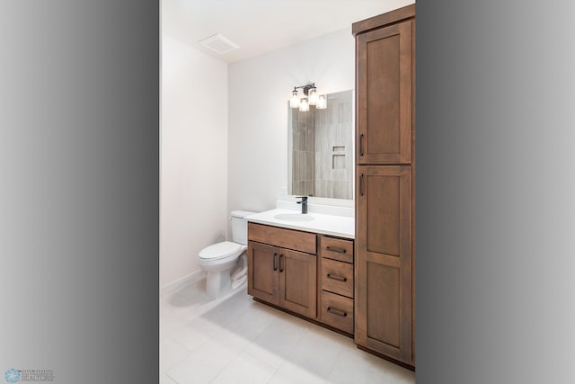 bathroom with a notable chandelier, toilet, and vanity