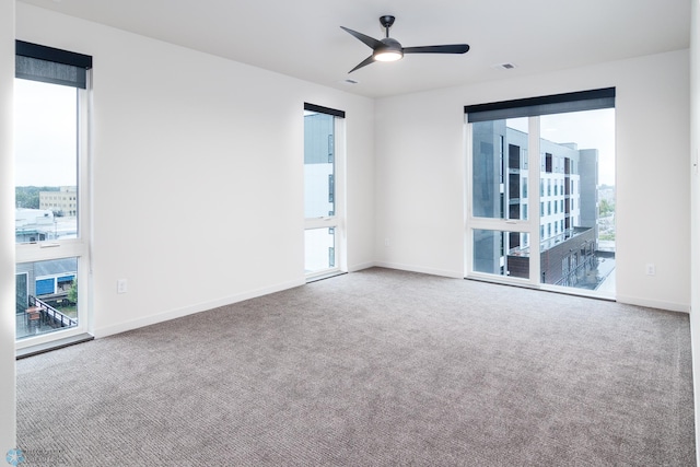 empty room featuring carpet flooring and ceiling fan