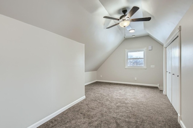 additional living space with vaulted ceiling, carpet floors, and ceiling fan