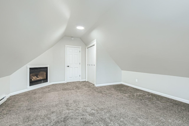 bonus room featuring lofted ceiling and carpet flooring