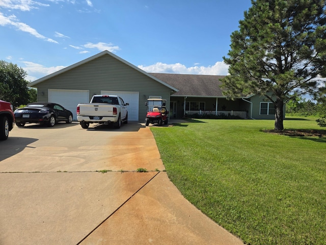 ranch-style house featuring a garage and a front lawn