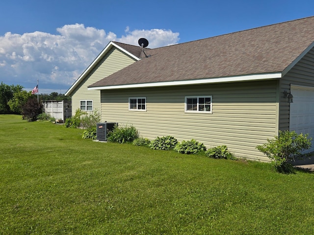 view of side of property with a yard and cooling unit