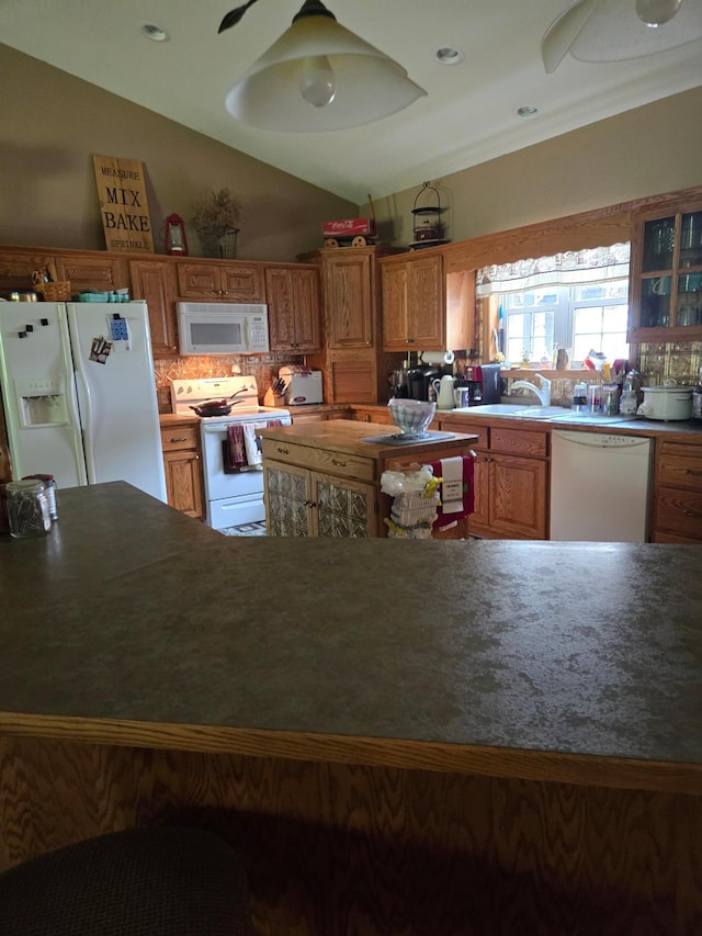 kitchen with lofted ceiling, decorative backsplash, ceiling fan, and white appliances