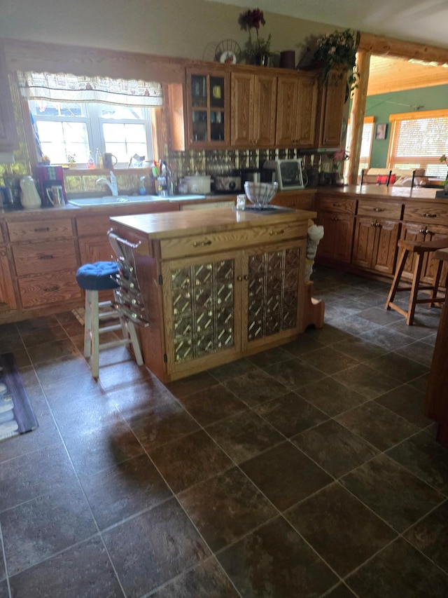 kitchen with backsplash and dark tile patterned flooring