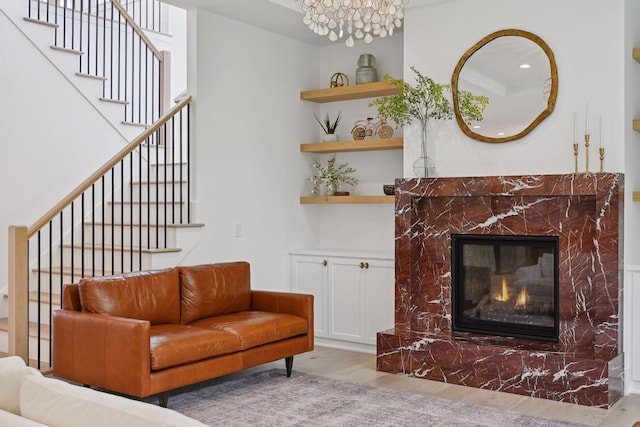 living room featuring a premium fireplace and wood-type flooring