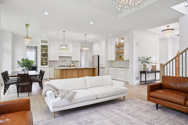21412 Poate Ct, Rogers, MN 55374 - living room featuring a notable chandelier, light wood-type flooring, visible vents, and recessed lighting