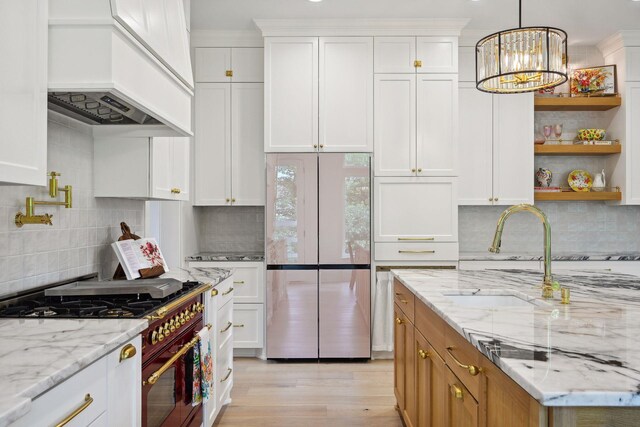 21412 Poate Ct, Rogers, MN 55374 - kitchen with premium range hood, appliances with stainless steel finishes, a sink, and white cabinets