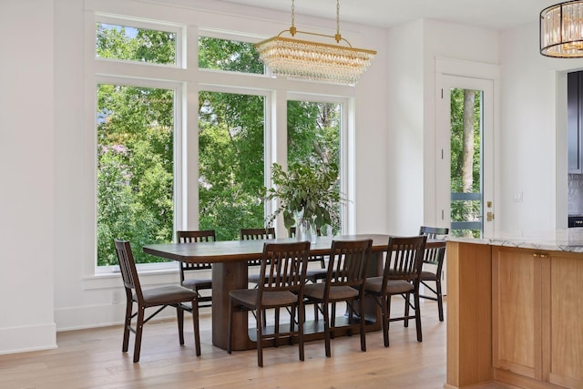 21412 Poate Ct, Rogers, MN 55374 - dining room featuring a chandelier, plenty of natural light, and light wood-style floors