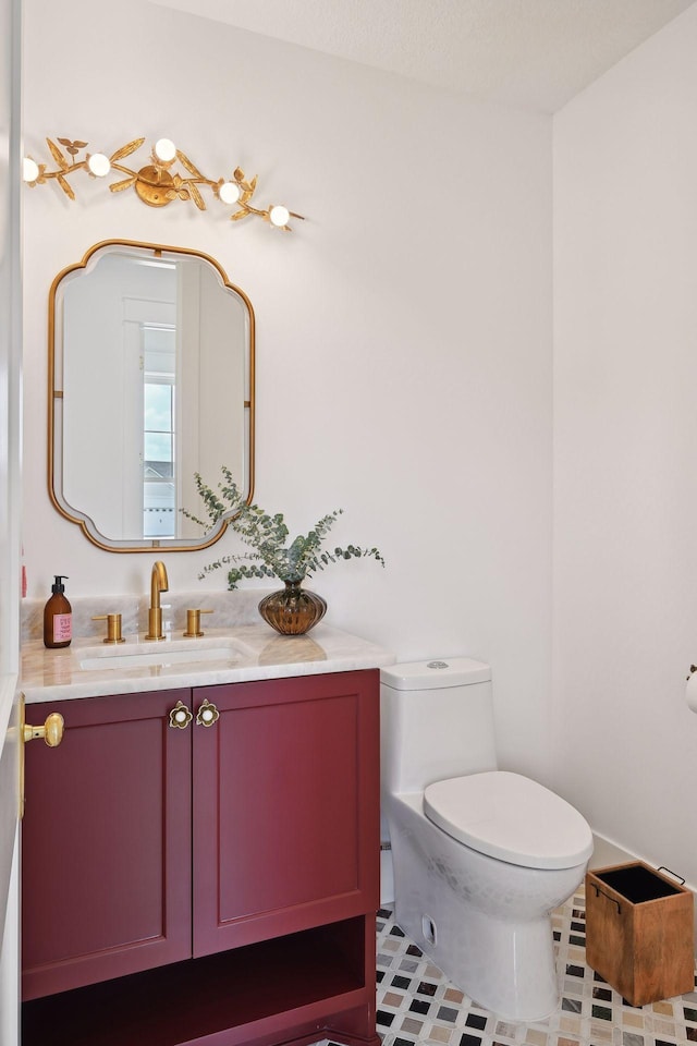 bathroom featuring vanity, toilet, and tile patterned floors