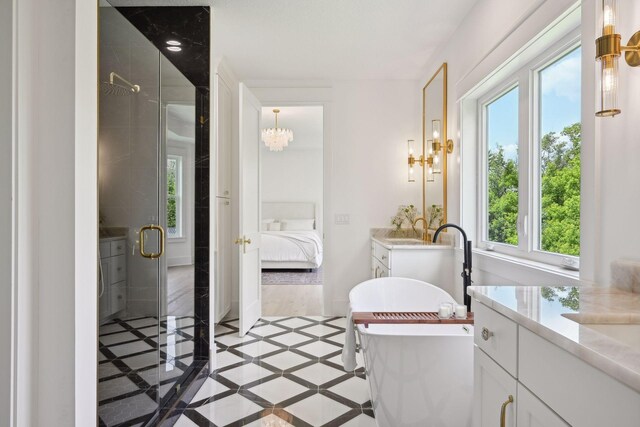 bathroom with walk in shower, tile patterned floors, vanity, and plenty of natural light