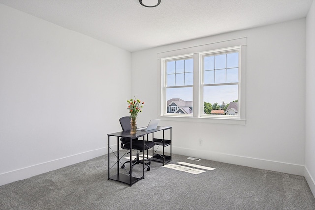 home office featuring carpet and a textured ceiling