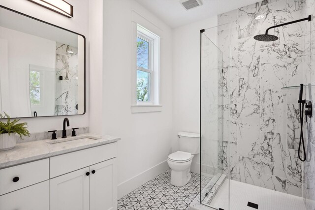 21412 Poate Ct, Rogers, MN 55374 - full bath with baseboards, toilet, visible vents, vanity, and a marble finish shower