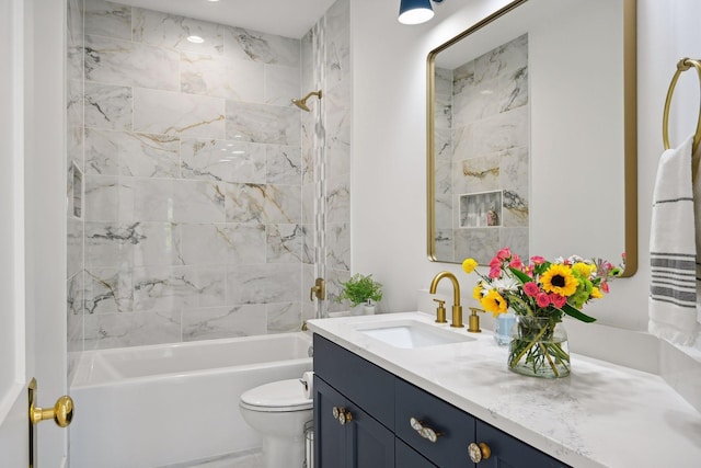 full bathroom featuring vanity, tiled shower / bath, and toilet