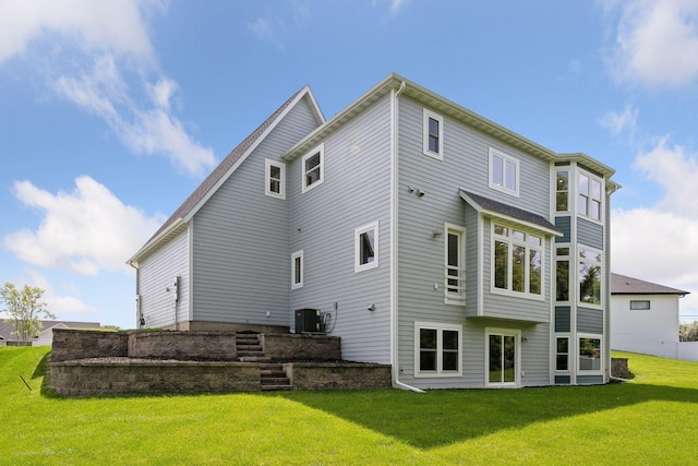 back of house featuring central AC and a lawn