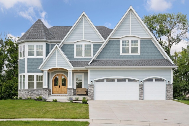 21412 Poate Ct, Rogers, MN 55374 - shingle-style home with driveway, roof with shingles, a front lawn, and stone siding