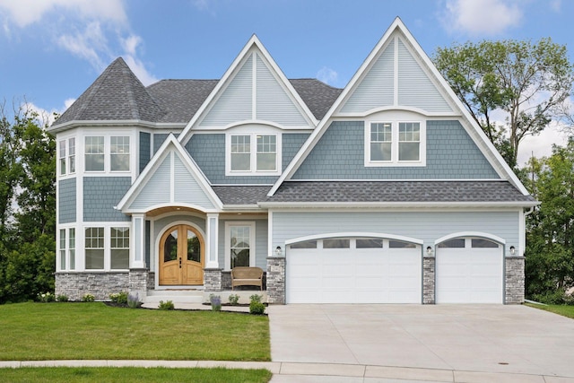 21412 Poate Ct, Rogers, MN 55374 - shingle-style home featuring concrete driveway, a shingled roof, a front lawn, and stone siding