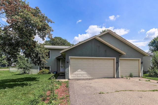 view of front of property featuring a garage and a front lawn