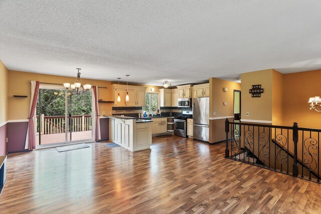 kitchen featuring stainless steel appliances, wood-type flooring, and a wealth of natural light