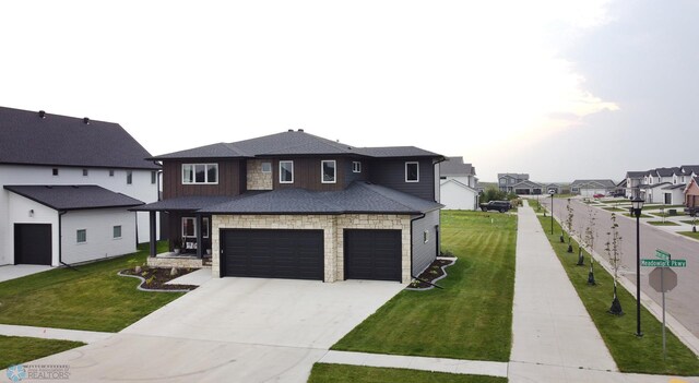 view of front facade with a garage and a front lawn