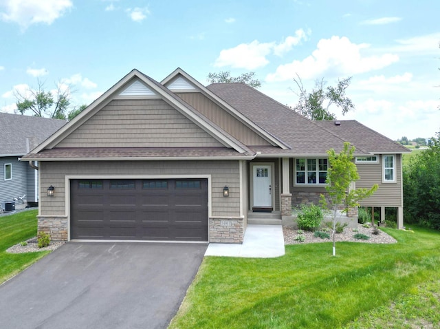 craftsman-style house featuring a front yard and a garage