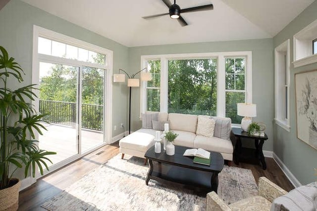 sunroom featuring lofted ceiling and ceiling fan