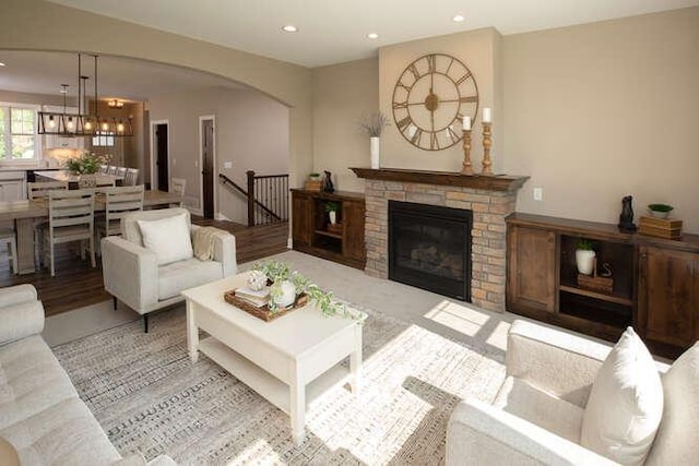 living room with an inviting chandelier and a fireplace