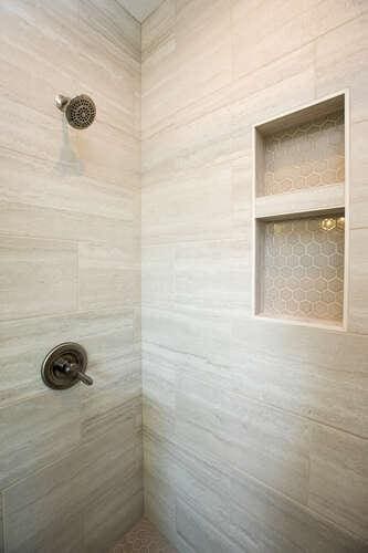 bathroom with tiled shower