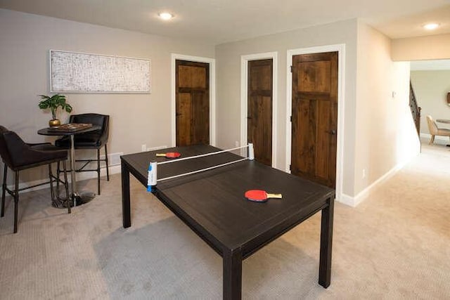 recreation room featuring light colored carpet