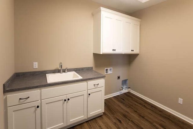 laundry area featuring electric dryer hookup, washer hookup, sink, cabinets, and dark hardwood / wood-style flooring