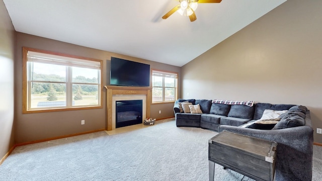 living room with ceiling fan, carpet floors, and lofted ceiling